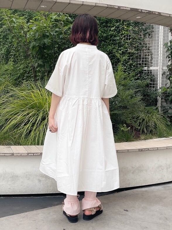 ホワイト系のワンピース、ベージュ系のサンダル、ピンク系のスラックスを着用したレディースの夏コーディネートの3枚目の写真