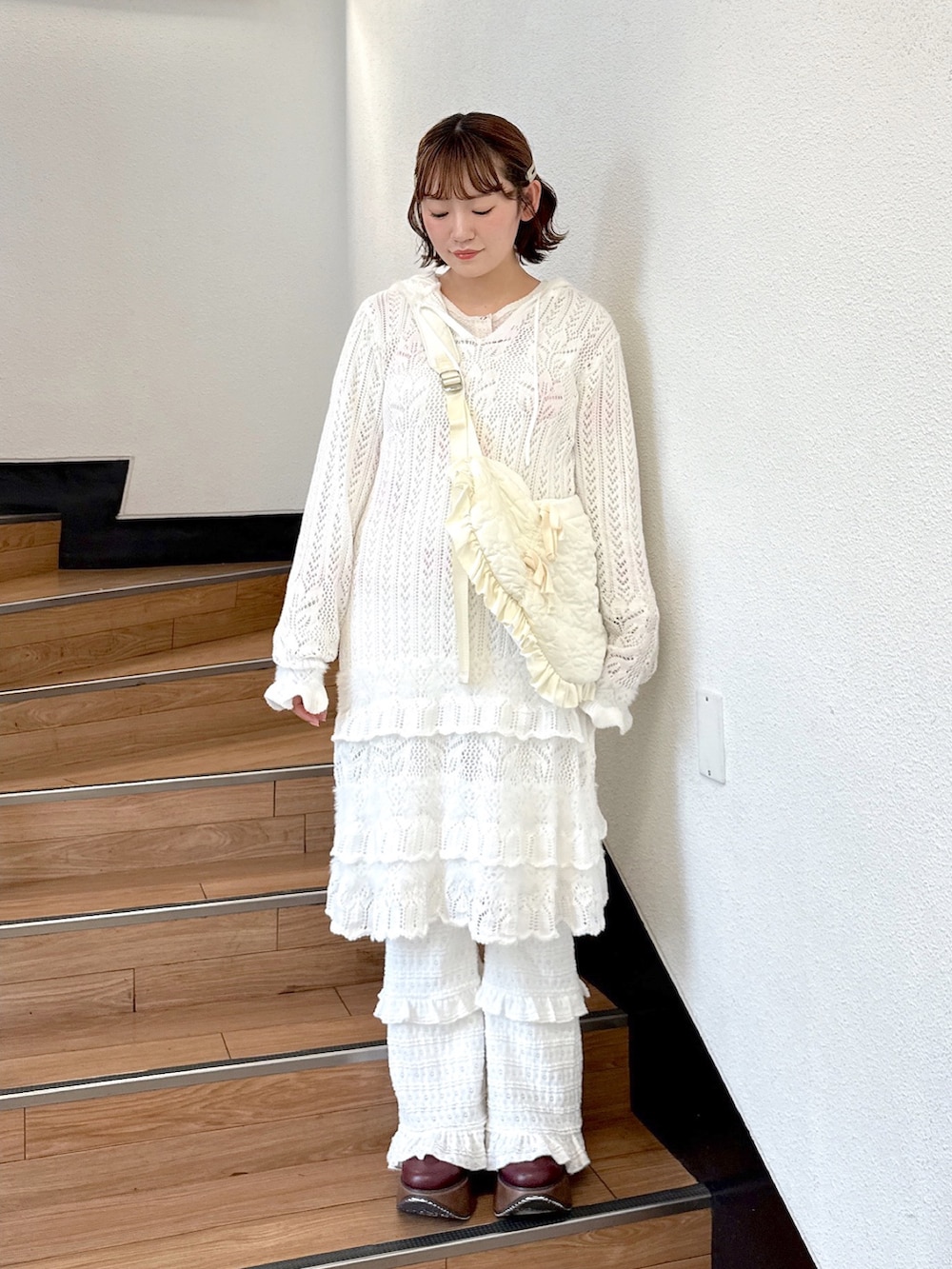 ホワイト系のショルダーバッグ、ピンク系のTシャツ/カットソー、ホワイト系のワンピースを着用したレディースの夏コーディネートの2枚目の写真