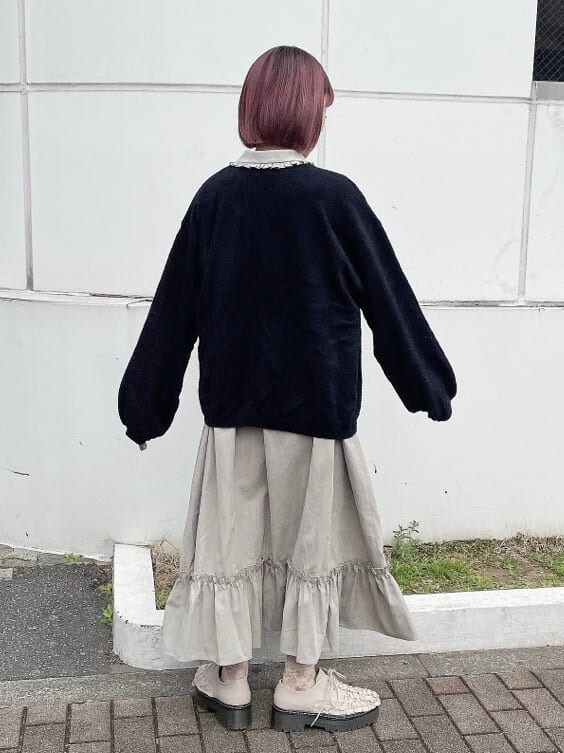 ベージュ系のワンピース、ピンク系のその他シューズ、ブラック系のカーディガン/ボレロを着用したレディースの冬コーディネートの2枚目の写真