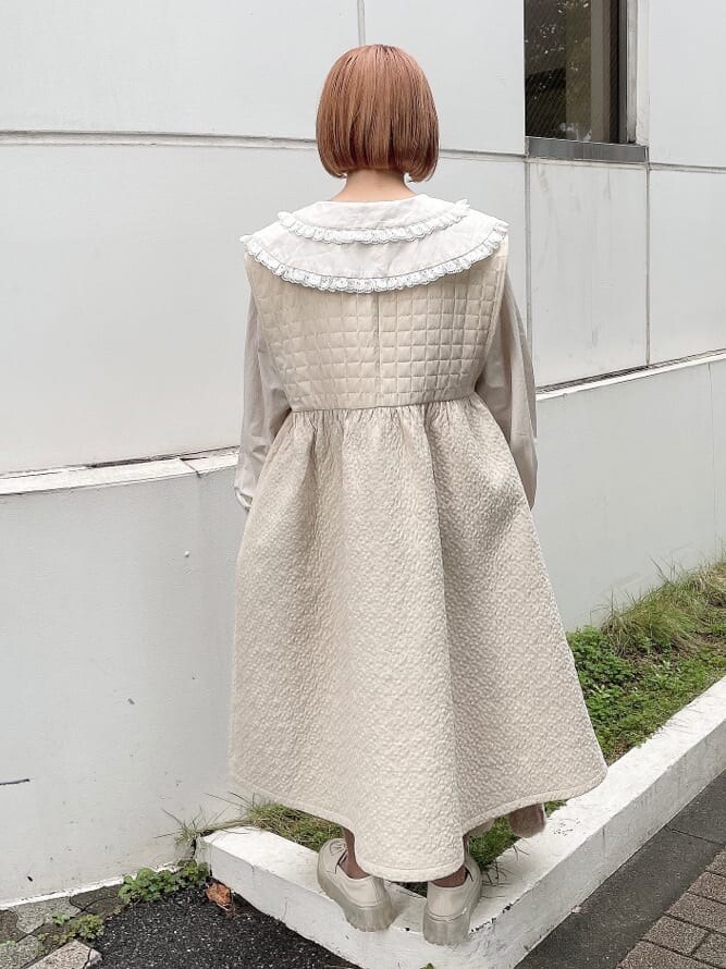 ベージュ系のハンドバッグ、ホワイト系のワンピース、ベージュ系のシャツ/ブラウスを着用したレディースの秋コーディネートの4枚目の写真