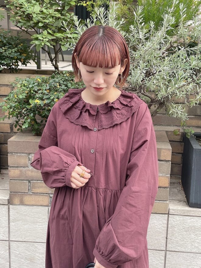 ブルー系のチェスターコート、レッド系のワンピース、その他のパンプスを着用したレディースの秋コーディネートの6枚目の写真