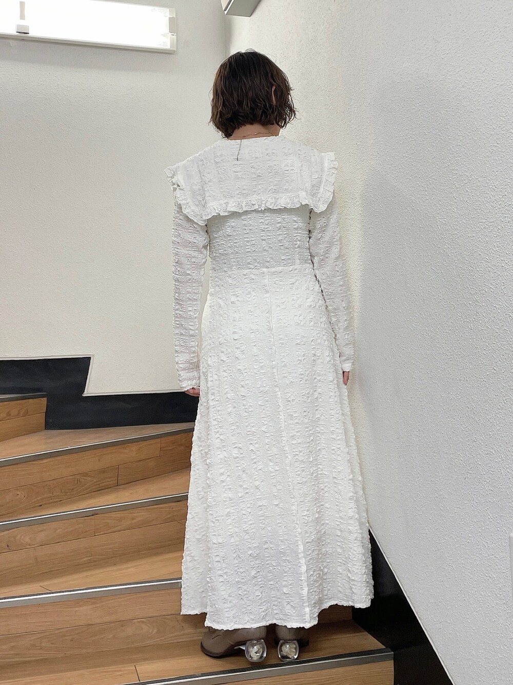 ホワイト系のワンピース、ベージュ系のブーツを着用したレディースの秋コーディネートの3枚目の写真