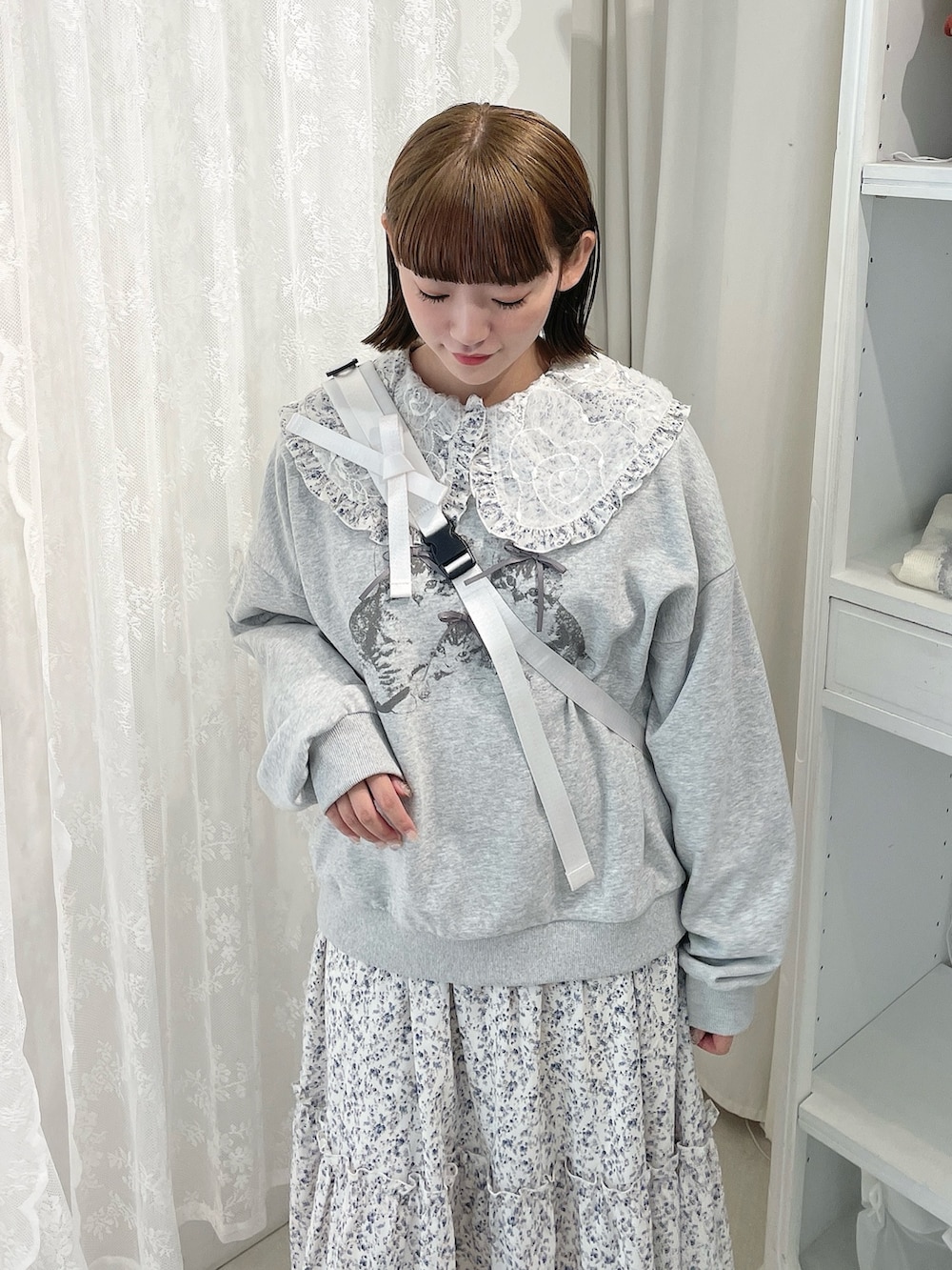 ブラック系のローファー、グレー系のスウェット、ホワイト系のショルダーバッグを着用したレディースの冬コーディネートの5枚目の写真