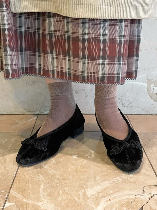 レッド系のワンピース、ブラック系のその他シューズ、ベージュ系のステンカラーコートを着用したレディースの秋コーディネートの5枚目の写真