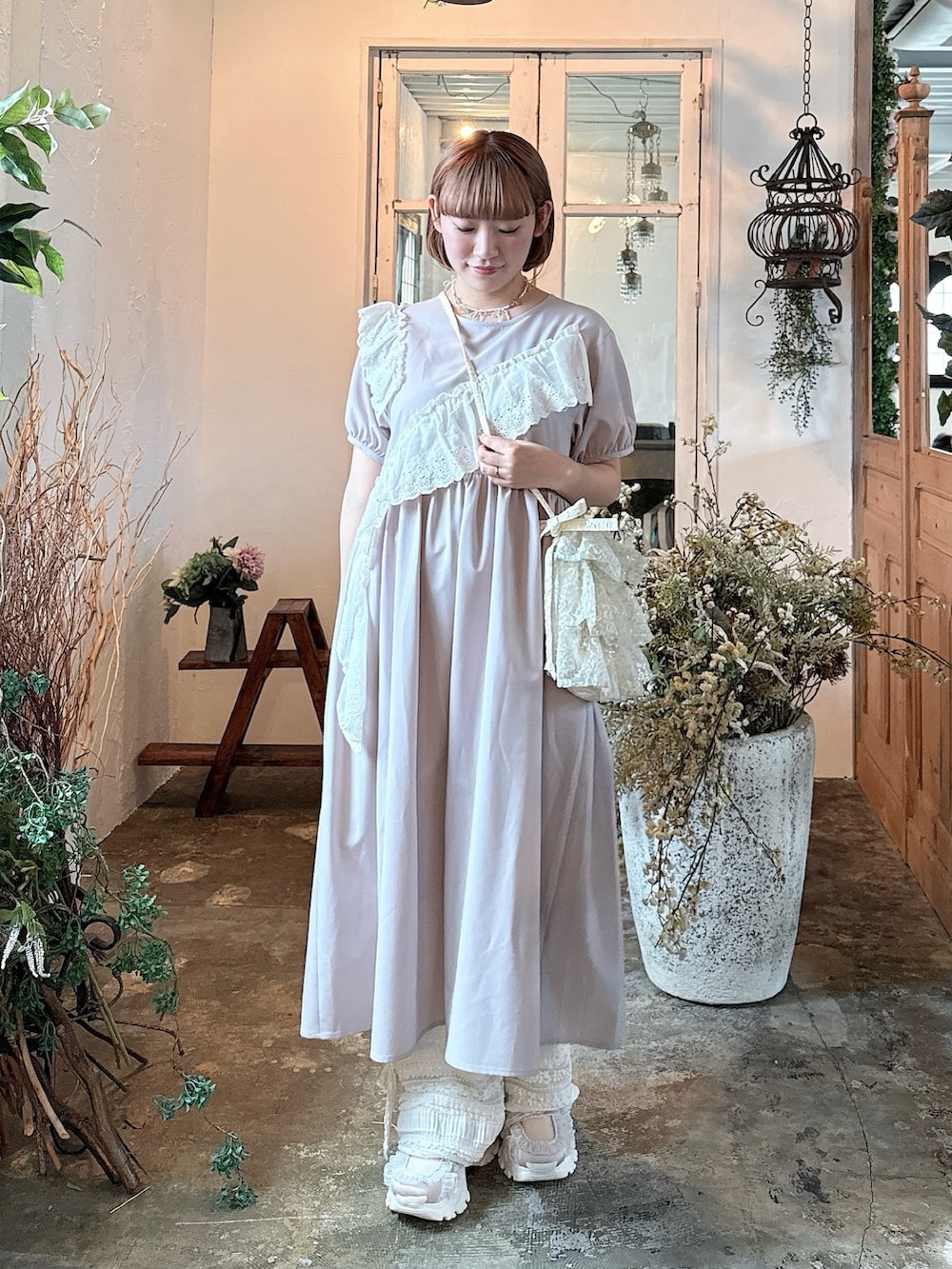 ピンク系のスニーカー、ホワイト系のその他パンツ、パープル系のワンピースを着用したレディースの春コーディネートの2枚目の写真