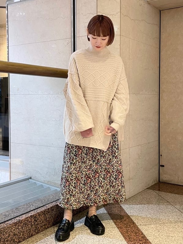 レッド系のスカート、ピンク系のチュニック、ブラック系のローファーを着用したレディースの秋コーディネートの2枚目の写真