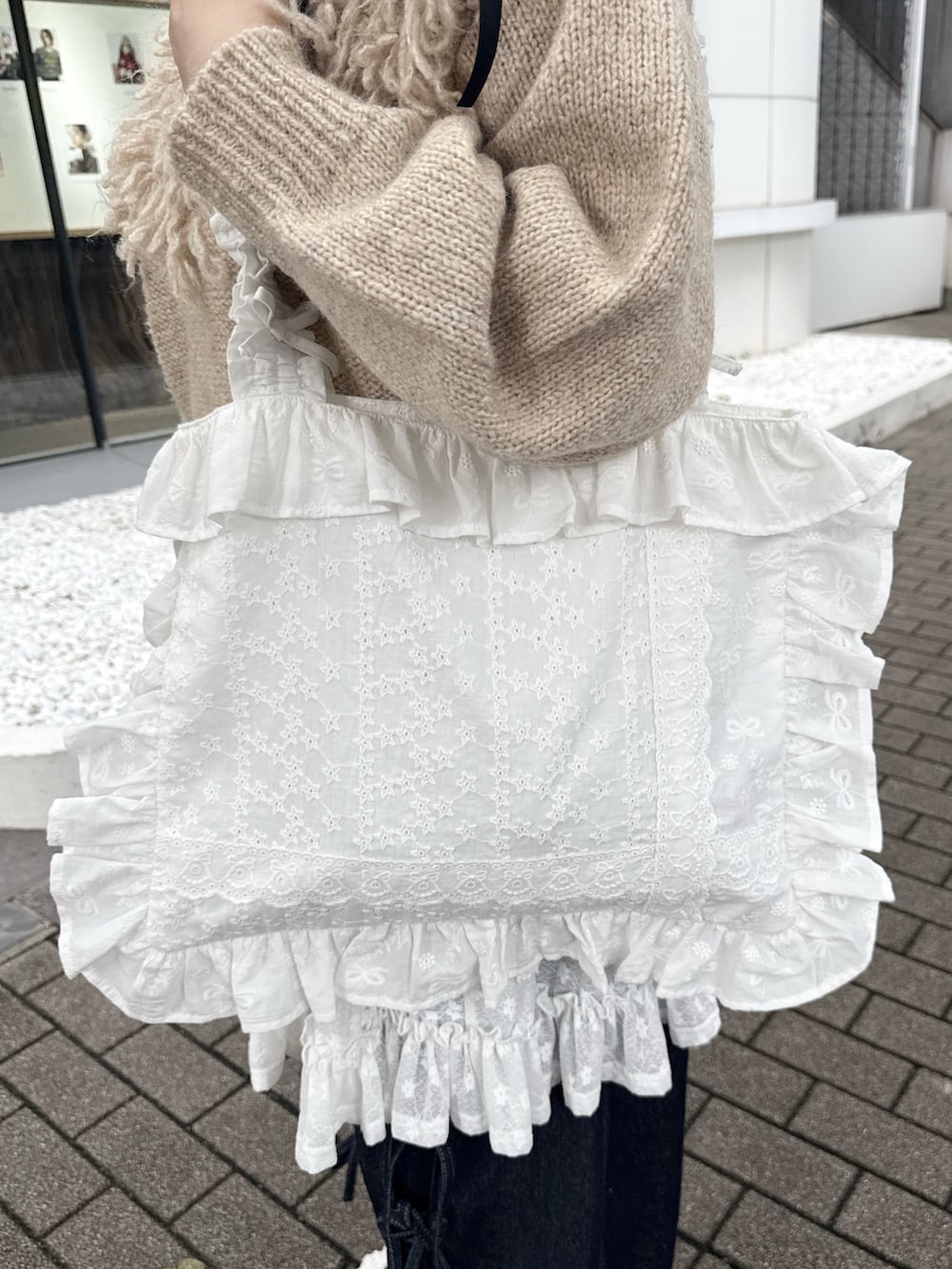 ブルー系のデニムパンツ、ホワイト系のスニーカー、ホワイト系のスカートを着用したレディースの夏コーディネートの6枚目の写真