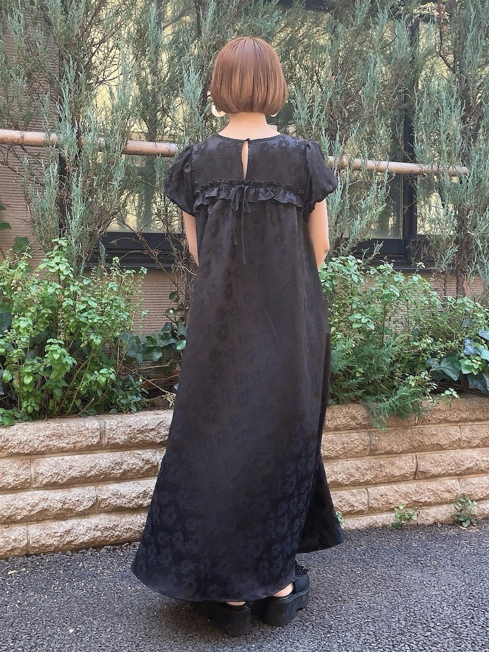 ブラック系のワンピース、ブラック系のサンダルを着用したレディースの春コーディネートの3枚目の写真