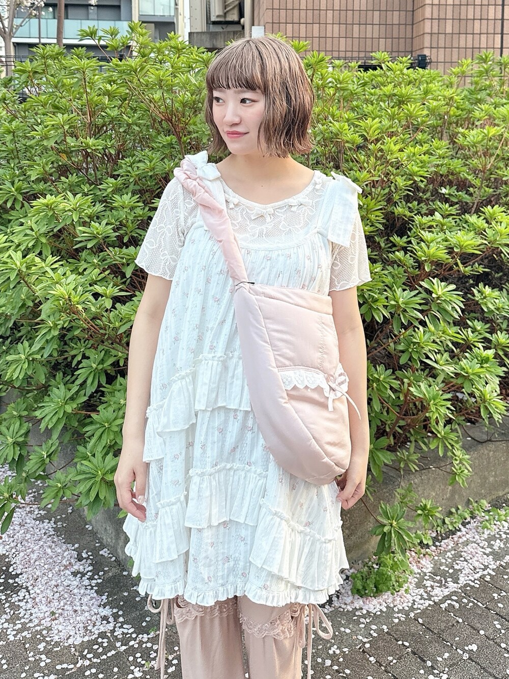 ピンク系のショルダーバッグ、ホワイト系のTシャツ/カットソー、ピンク系のワンピースを着用したレディースの春コーディネートの5枚目の写真