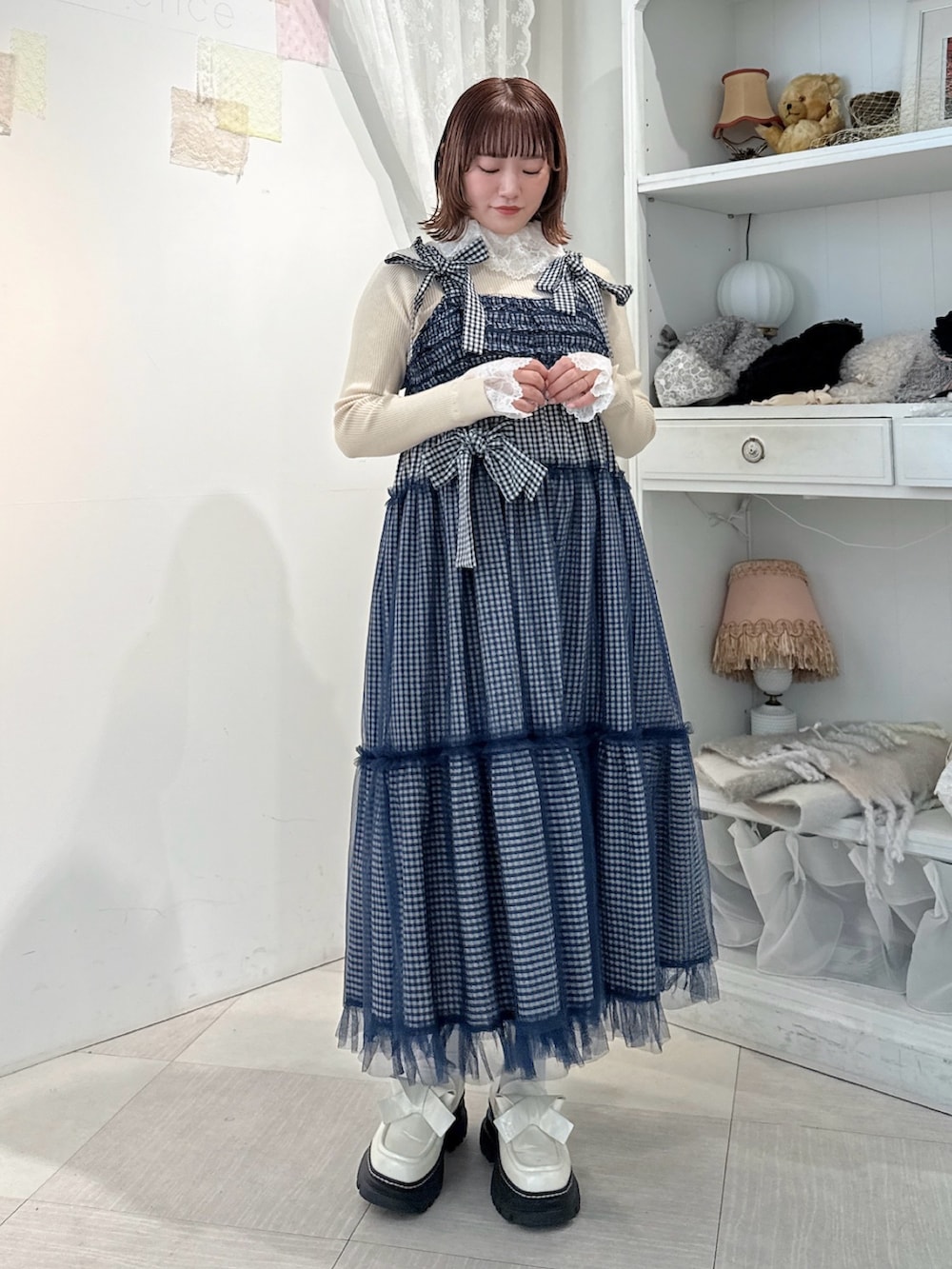 ホワイト系のニット/セーター、ブルー系のワンピース、ホワイト系のローファーを着用したレディースの冬コーディネートの2枚目の写真