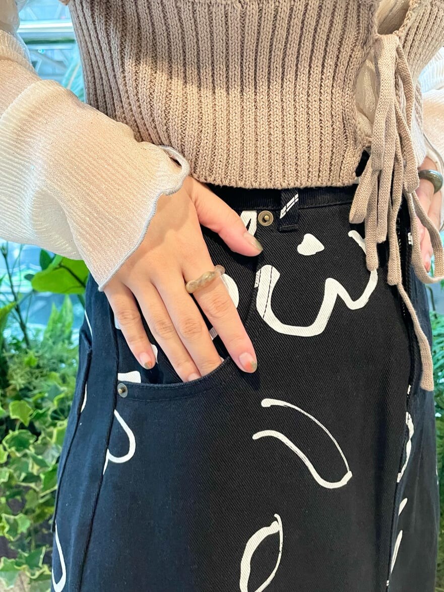 ベージュ系のニット/セーター、ホワイト系のチュニック、ブラック系のスカートを着用したレディースの夏コーディネートの6枚目の写真