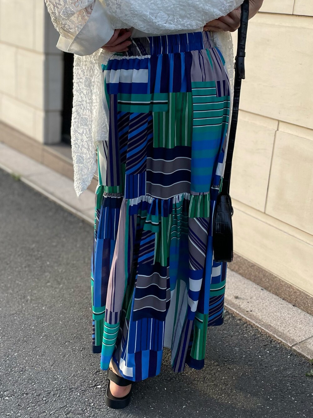 ホワイト系のシャツ/ブラウス、ブルー系のスカート、ホワイト系のタンクトップを着用したレディースの春コーディネートの3枚目の写真