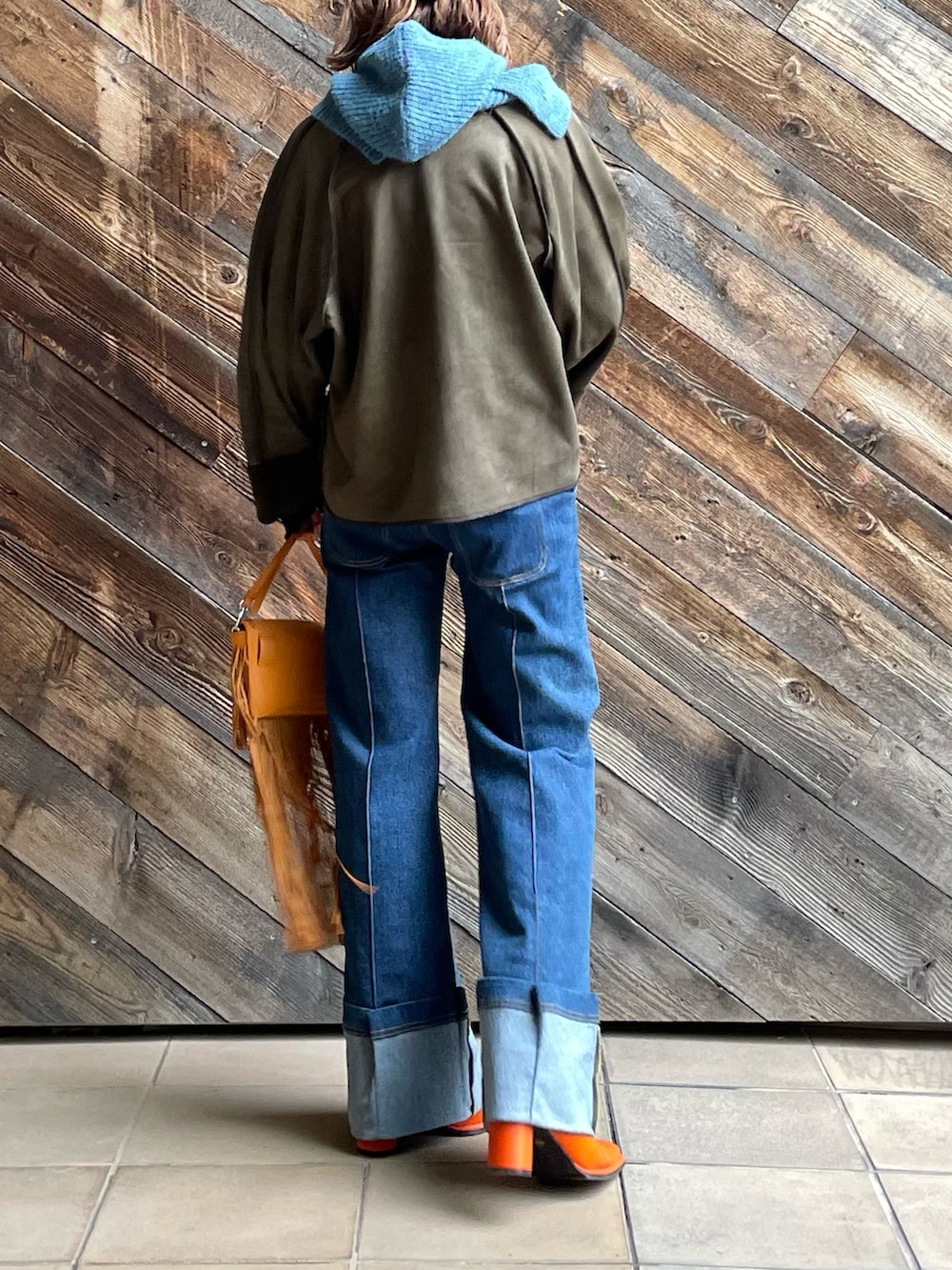 グリーン系のノーカラージャケット、ブルー系のネックウォーマー/スヌードを着用したレディースの秋コーディネートの2枚目の写真