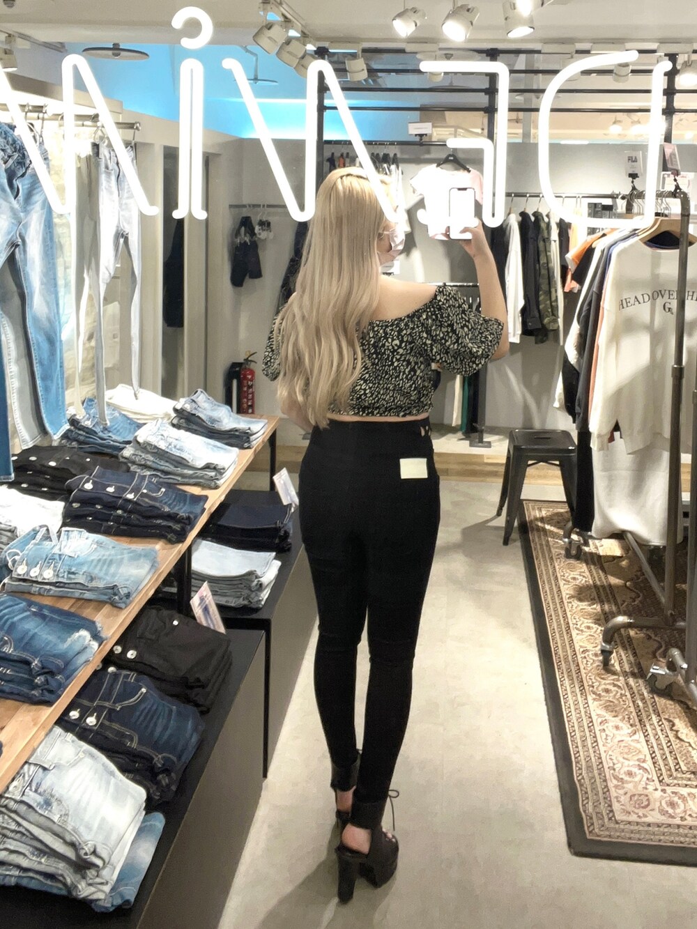 ブラック系のシャツ/ブラウス、ブラック系のデニムパンツ、ブラック系のブーツを着用したレディースの春コーディネートの2枚目の写真