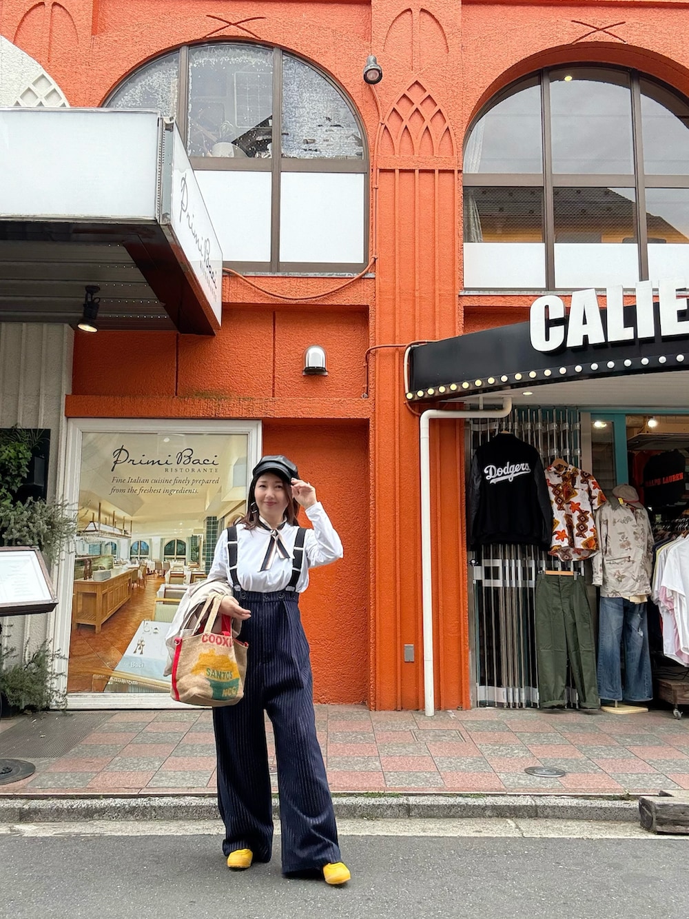 イエロー系のスニーカー、レッド系のトートバッグ、ベージュ系のテーラードジャケットを着用したレディースの春コーディネートの3枚目の写真