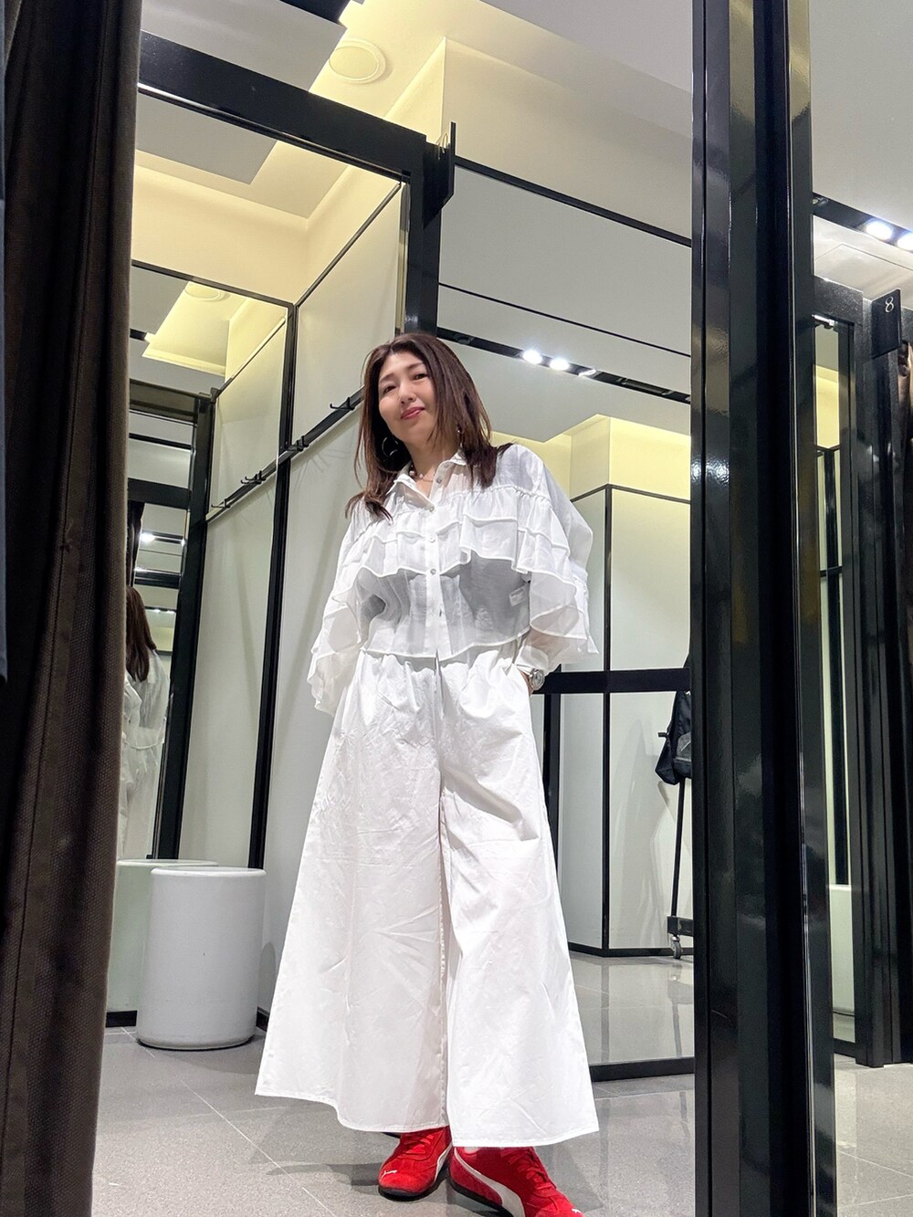 レッド系のスニーカー、ブラック系のTシャツ/カットソー、ホワイト系のTシャツ/カットソーを着用したレディースの春コーディネートの3枚目の写真