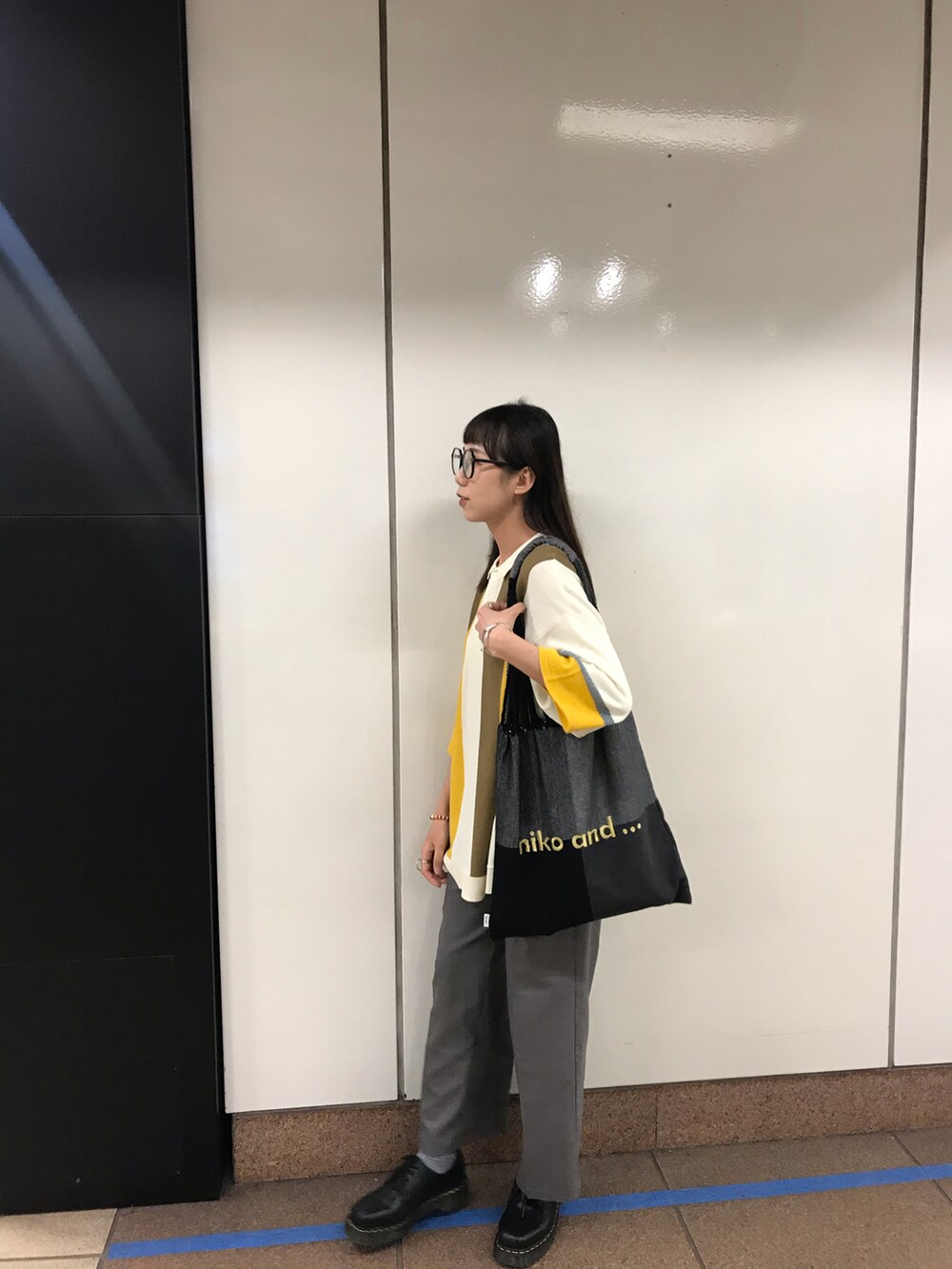 グレー系のスラックス、その他のポロシャツを着用したレディースの春コーディネートの2枚目の写真