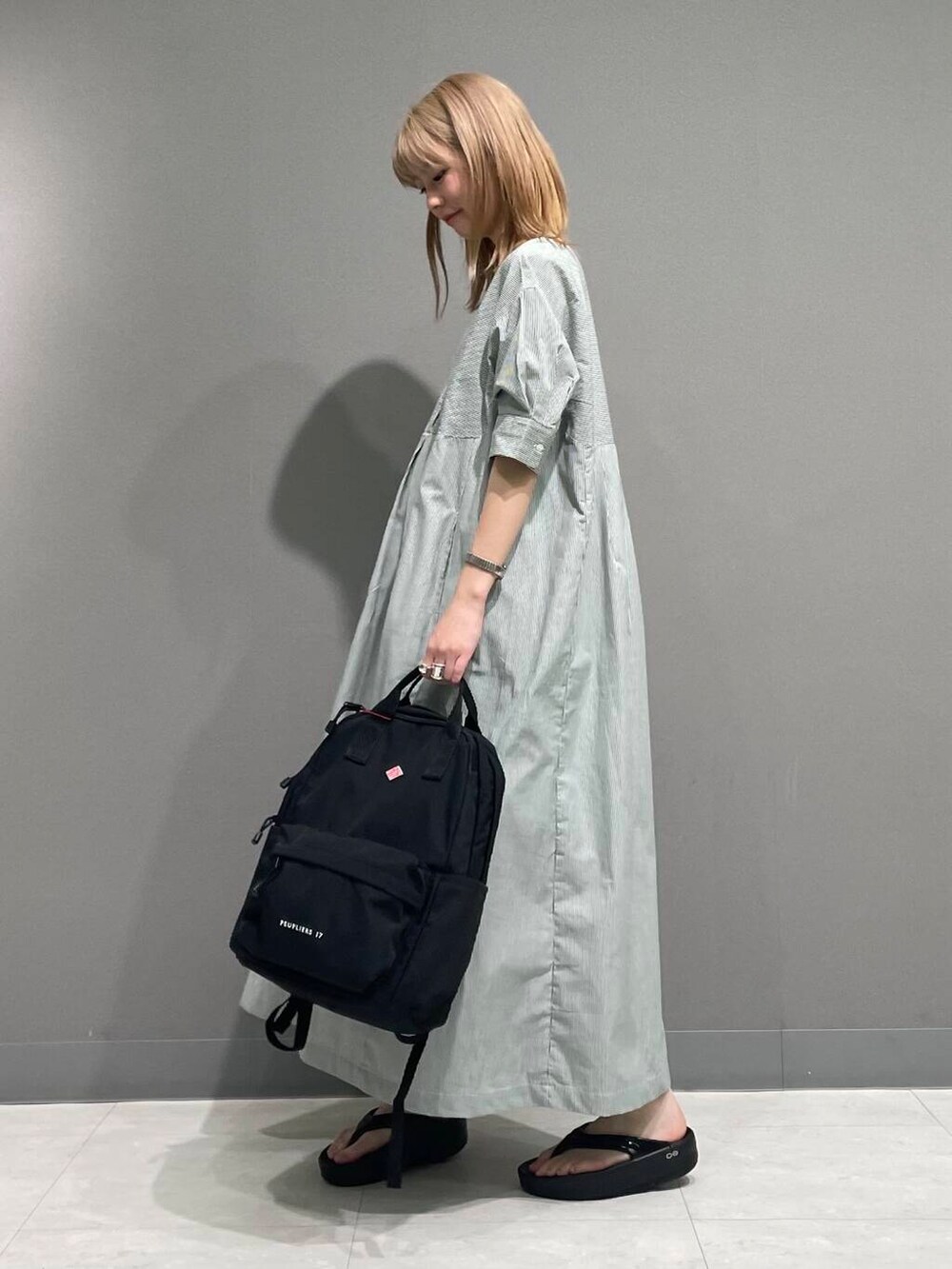 ブラック系のサンダル、グリーン系のワンピースを着用したレディースの夏コーディネートの6枚目の写真