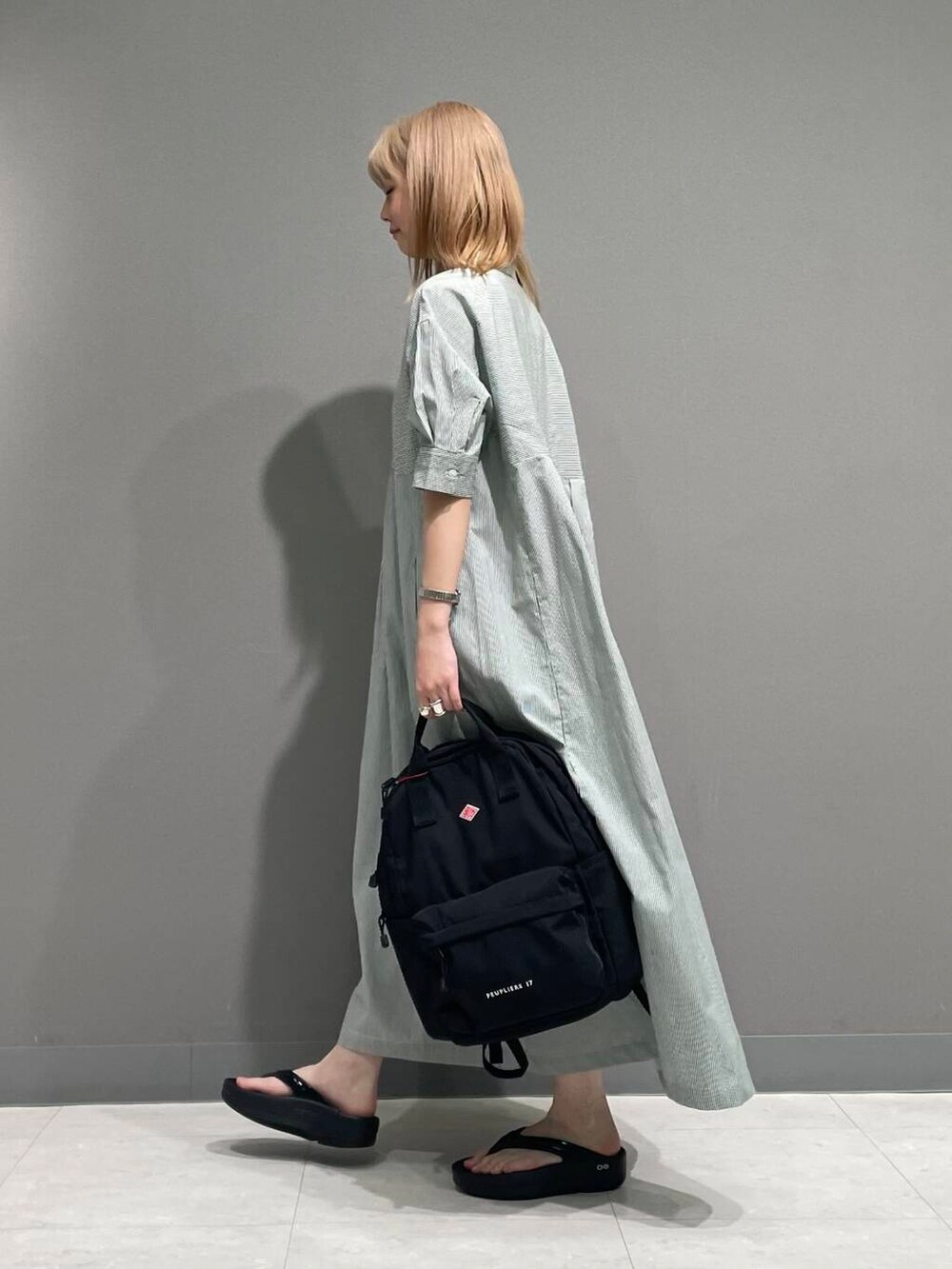 ブラック系のサンダル、グリーン系のワンピースを着用したレディースの夏コーディネートの7枚目の写真