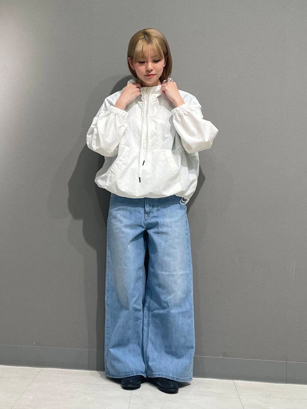 ブルー系のデニムパンツ、ホワイト系のパーカーを着用したレディースの春コーディネートの7枚目の写真