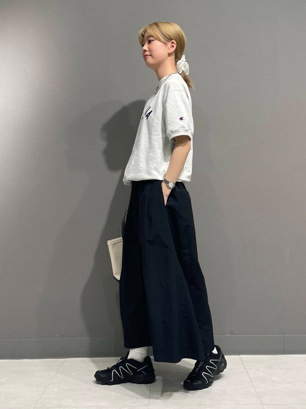 ブラック系のスカート、ホワイト系のヘアゴムを着用したレディースの春コーディネートの3枚目の写真