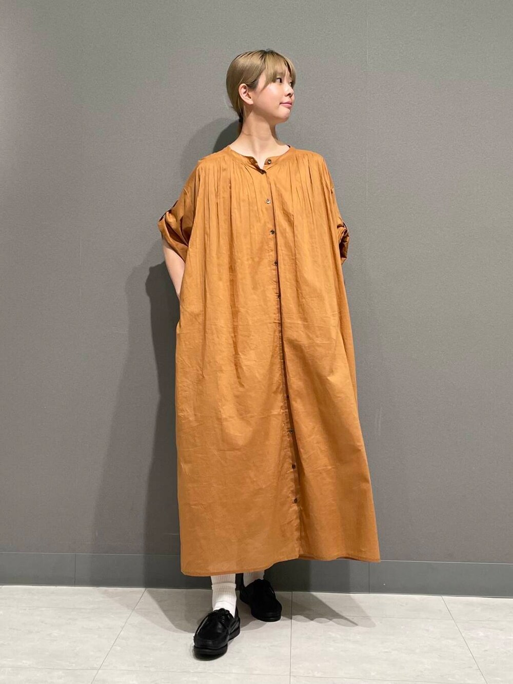 オレンジ系のワンピースを着用したレディースの春コーディネートの8枚目の写真