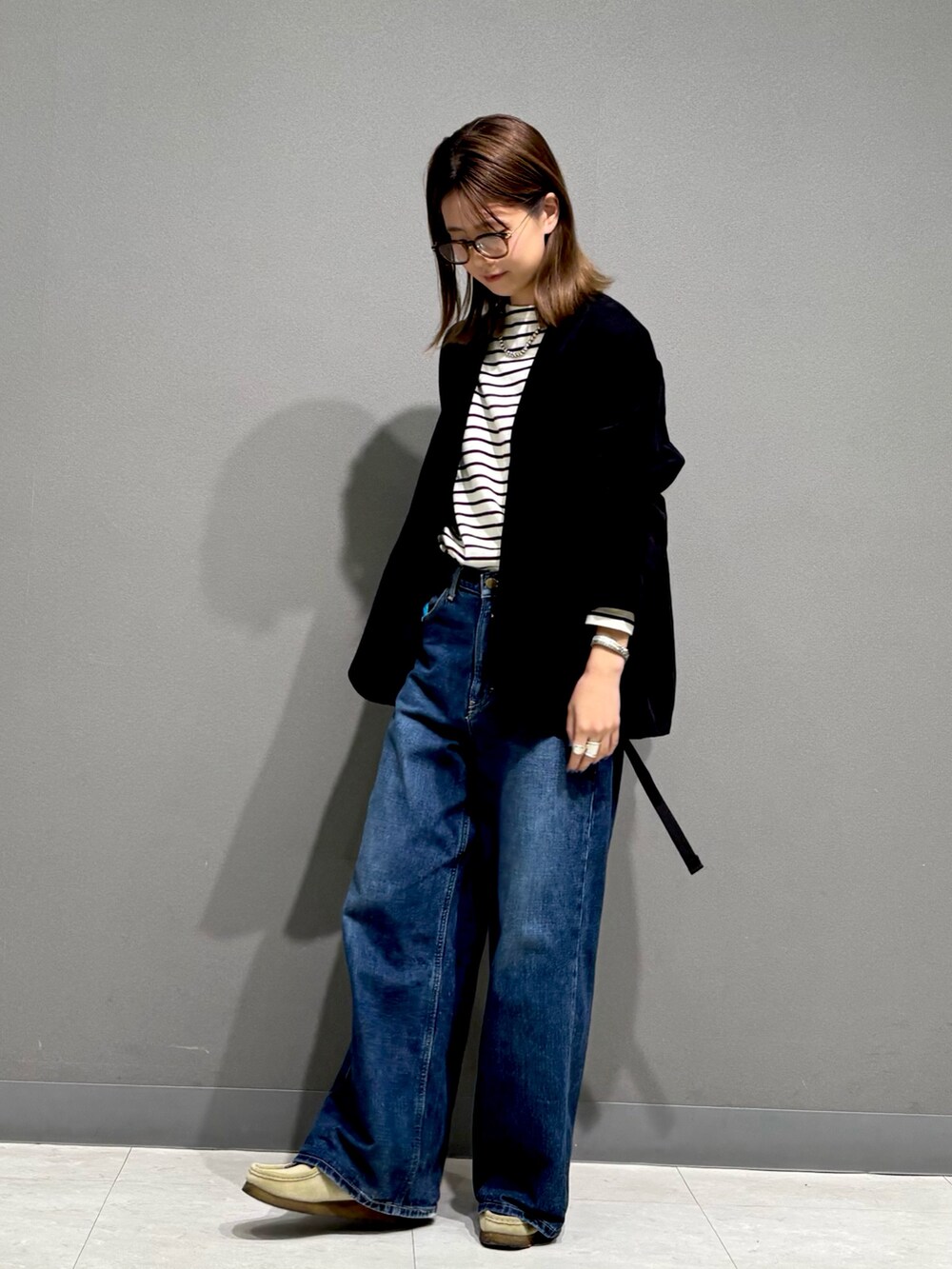 ブラック系のTシャツ/カットソー、ブラック系のノーカラージャケット、グレー系のバックパック/リュックを着用したレディースの秋コーディネートの2枚目の写真