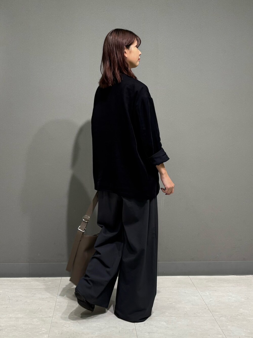 ブラック系のノーカラージャケット、グレー系のショルダーバッグを着用したレディースの秋コーディネートの5枚目の写真