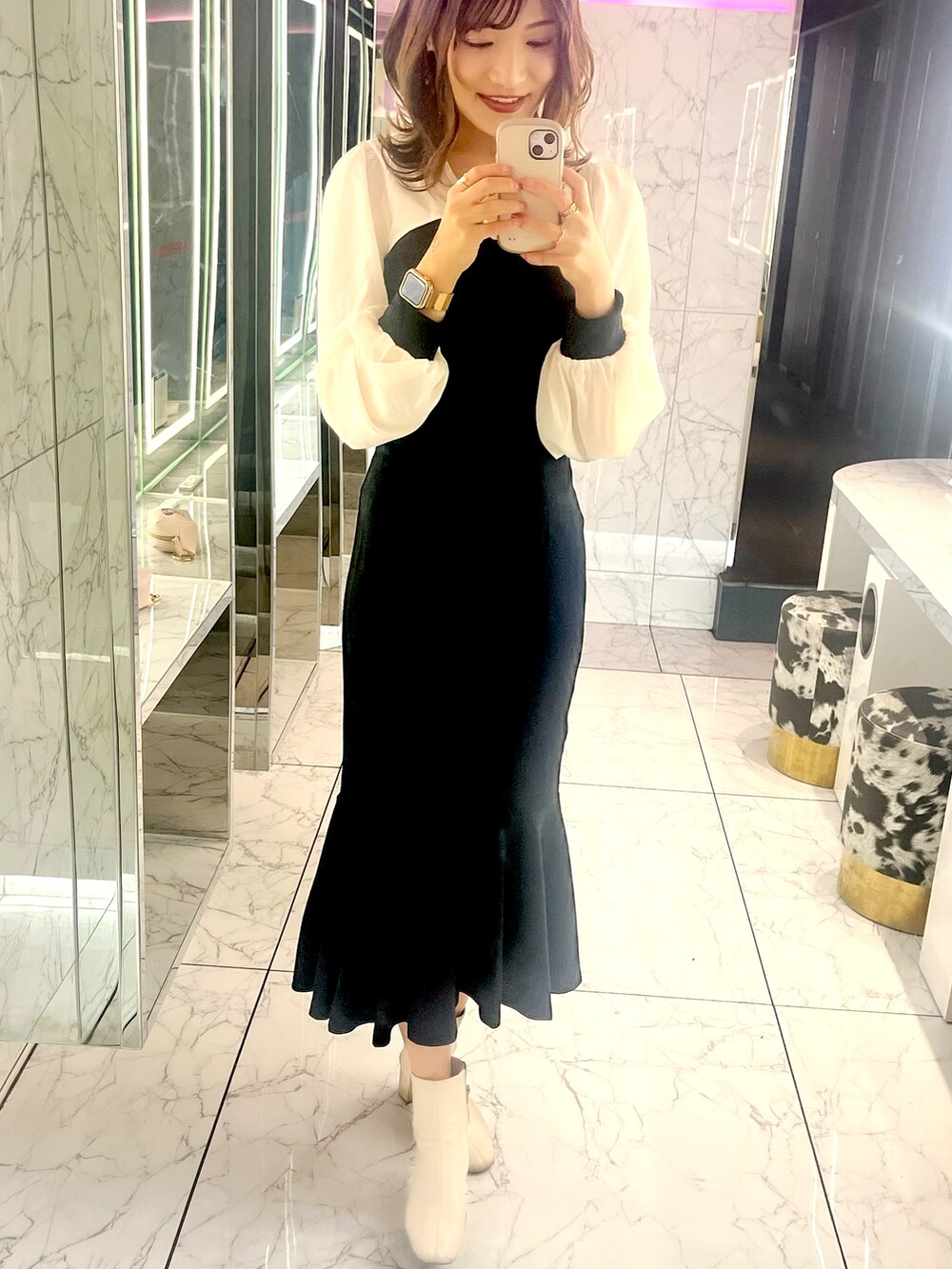 ブラック系のショルダーバッグ、ブラック系のワンピース、ゴールド系のリングを着用したレディースの春コーディネートの2枚目の写真