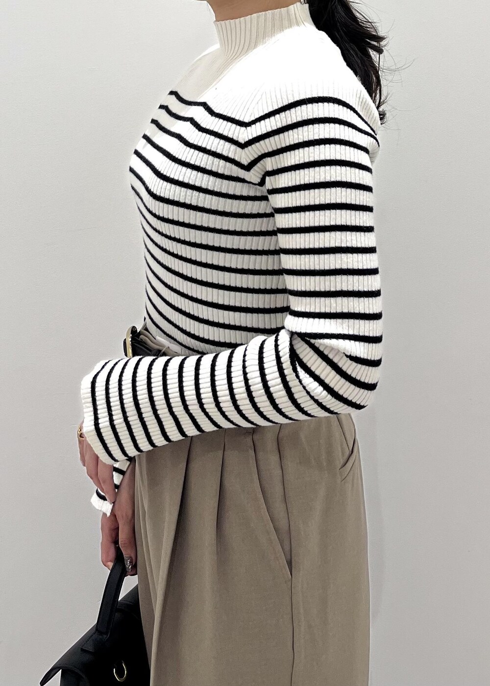 ブルー系のデニムジャケット、ホワイト系のニット/セーター、ベージュ系のスラックスを着用したレディースの冬コーディネートの9枚目の写真