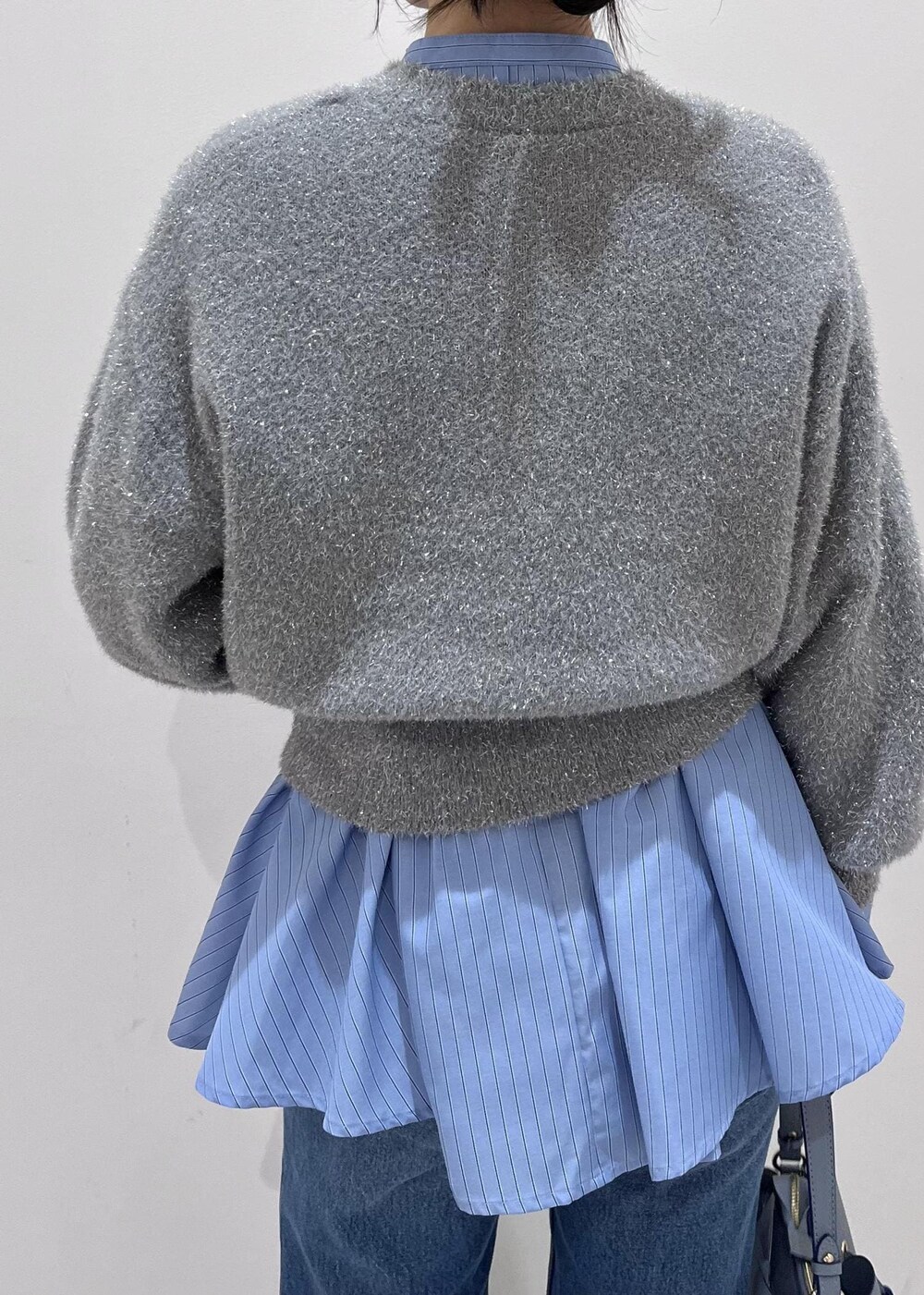 シルバー系のパンプス、ブルー系のデニムパンツ、ブルー系のシャツ/ブラウスを着用したレディースの冬コーディネートの7枚目の写真