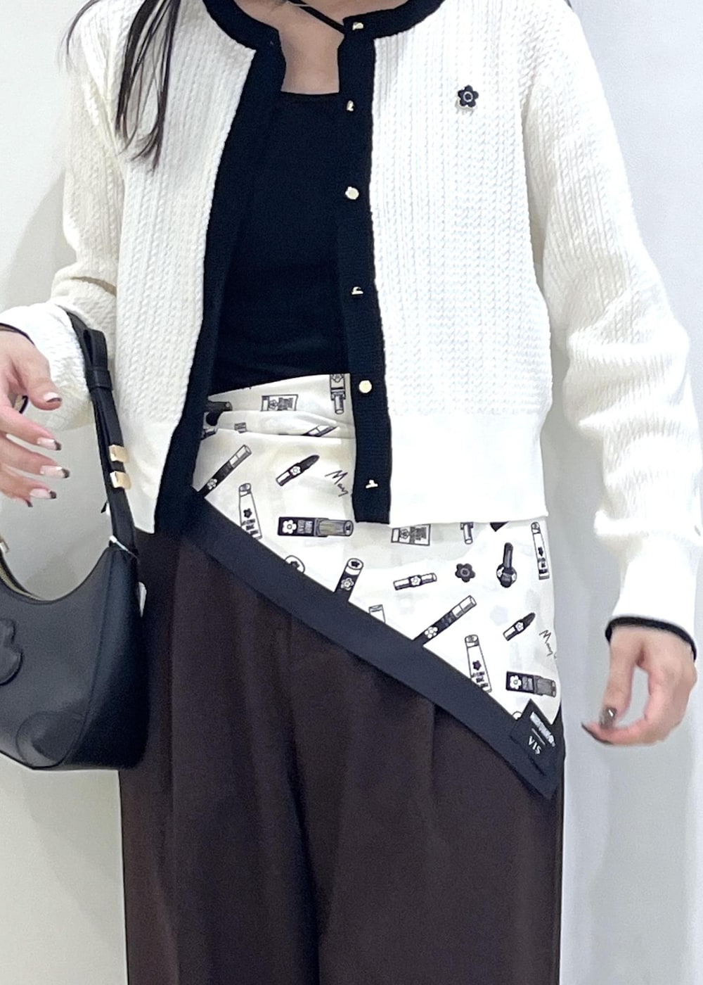 ブラック系のローファー、ブラウン系のその他パンツ、ホワイト系のカーディガン/ボレロを着用したレディースの秋コーディネートの5枚目の写真