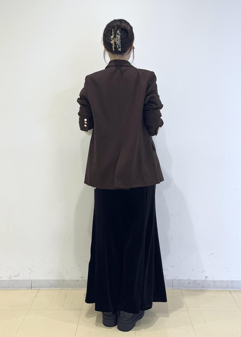ホワイト系のTシャツ/カットソー、ブラック系のブーツ、ブラック系のスカートを着用したレディースの秋コーディネートの2枚目の写真