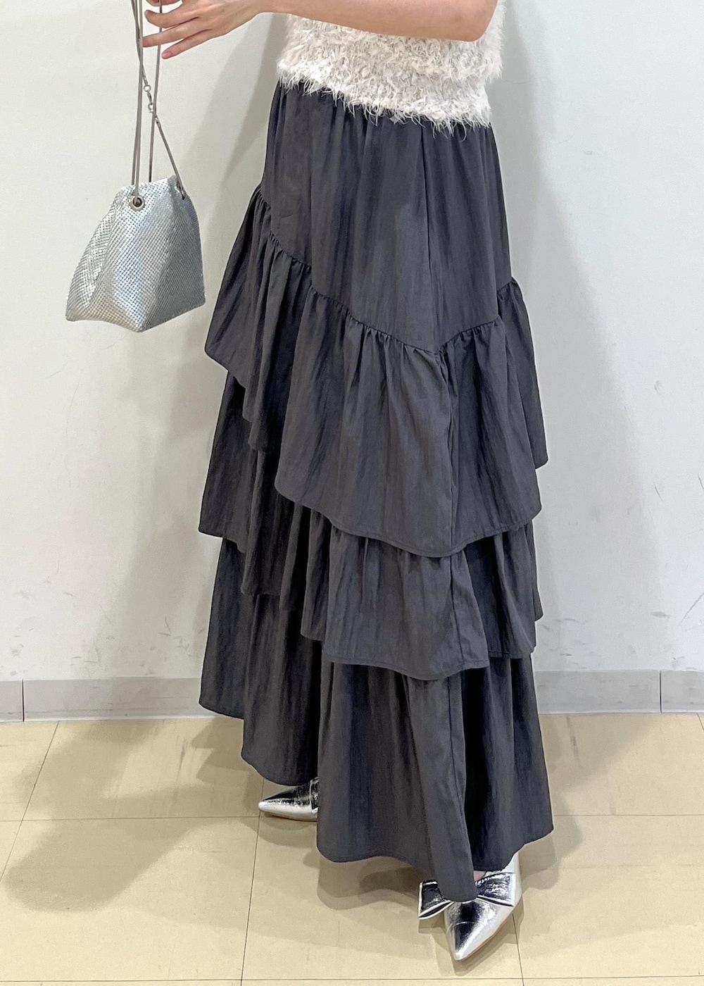 シルバー系のパンプス、シルバー系のショルダーバッグ、グレー系のスカートを着用したレディースの夏コーディネートの9枚目の写真