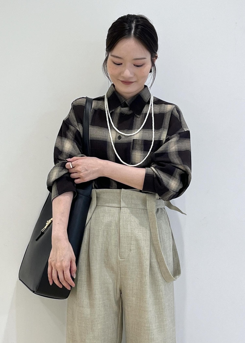 ブラック系のシャツ/ブラウス、ベージュ系のその他パンツ、ブラック系のトートバッグを着用したレディースの秋コーディネートの4枚目の写真
