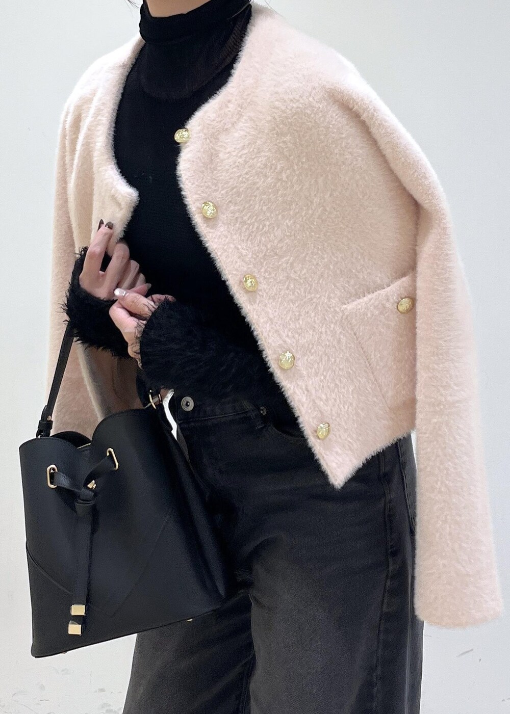 ブラック系のショルダーバッグ、グレー系のデニムパンツ、ピンク系のカーディガン/ボレロを着用したレディースの秋コーディネートの9枚目の写真