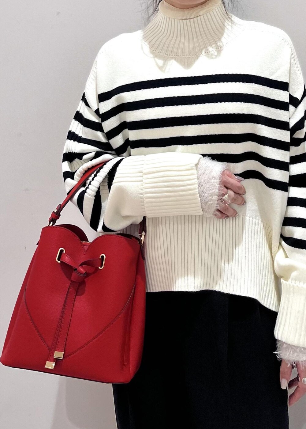 ブラック系のパンプス、ホワイト系のニット/セーター、ホワイト系のニット/セーターを着用したレディースの冬コーディネートの9枚目の写真