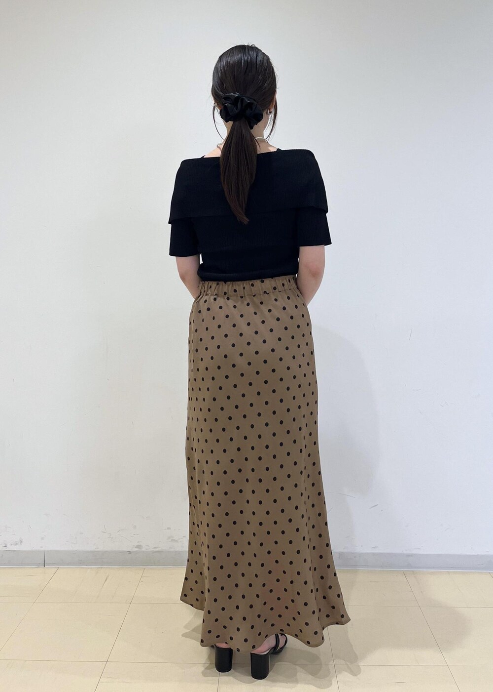 ブラック系のサンダル、ブラウン系のショルダーバッグ、ブラウン系のスカートを着用したレディースの夏コーディネートの3枚目の写真