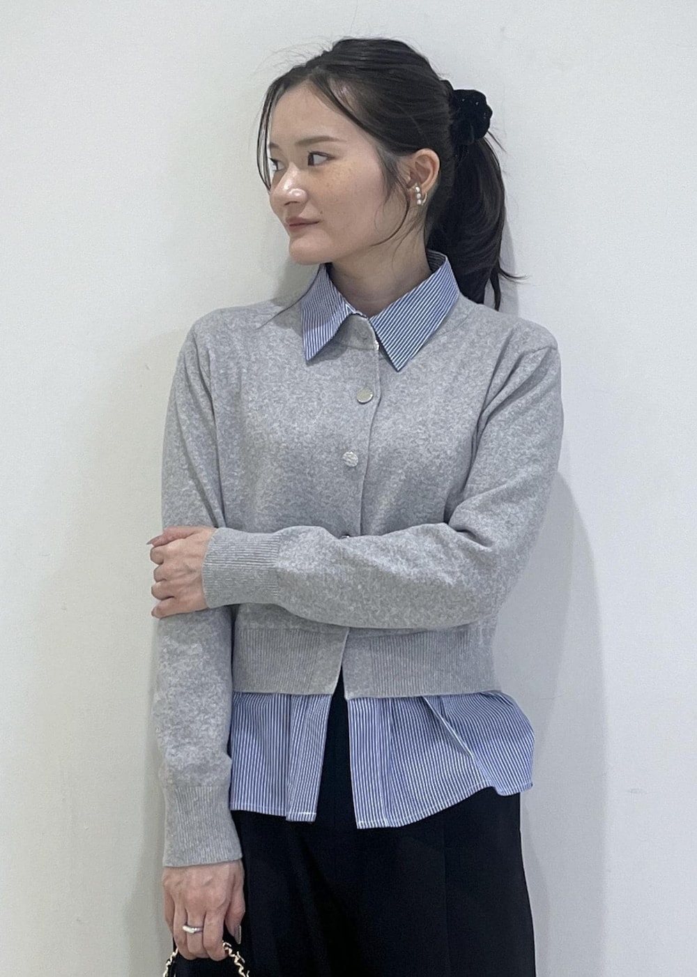 ホワイト系のパンプス、グレー系のカーディガン/ボレロ、ブラック系のスラックスを着用したレディースの冬コーディネートの5枚目の写真