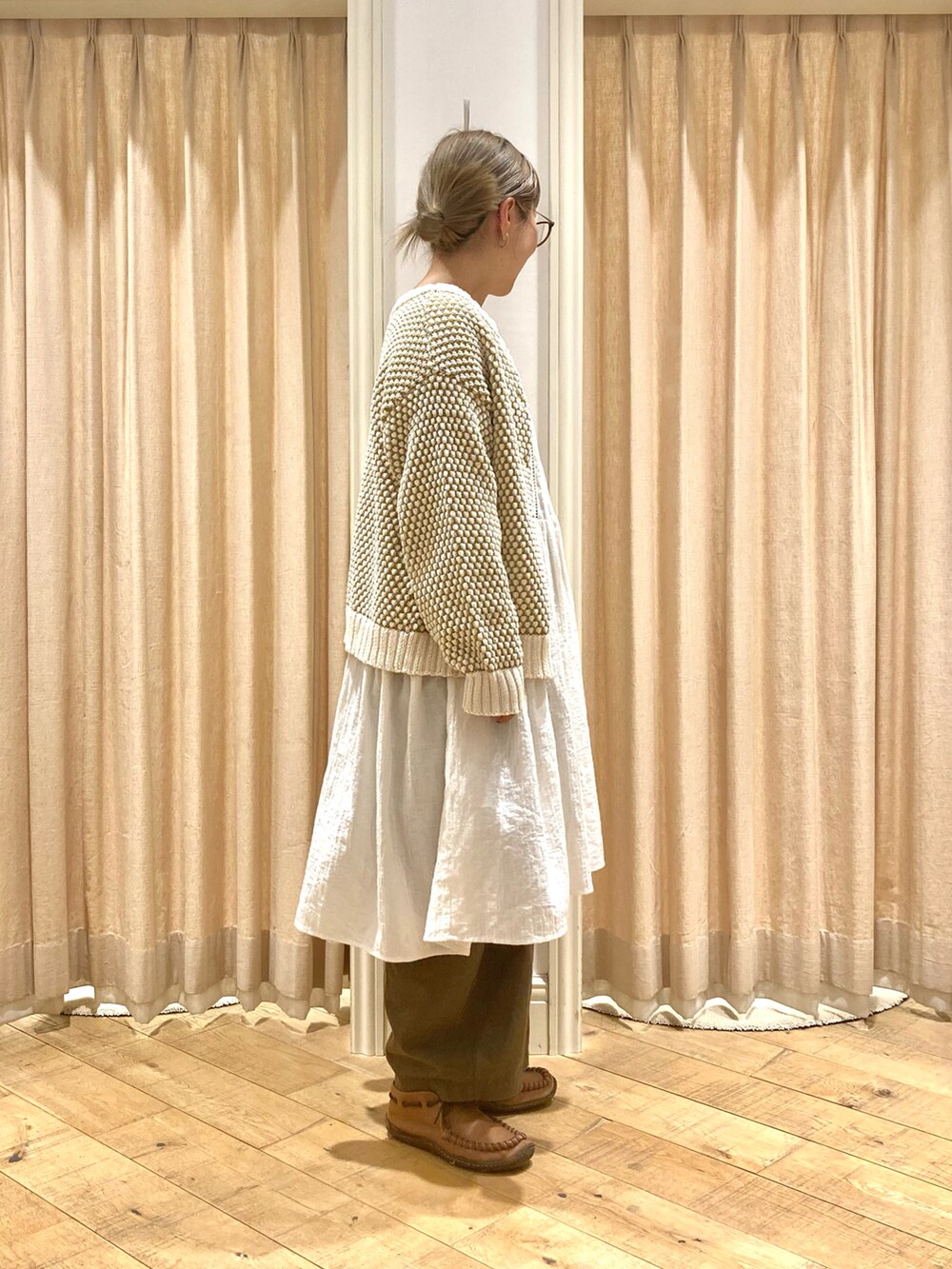 ホワイト系のチュニック、イエロー系のカーディガン/ボレロ、グリーン系のその他パンツを着用したレディースの冬コーディネートの5枚目の写真