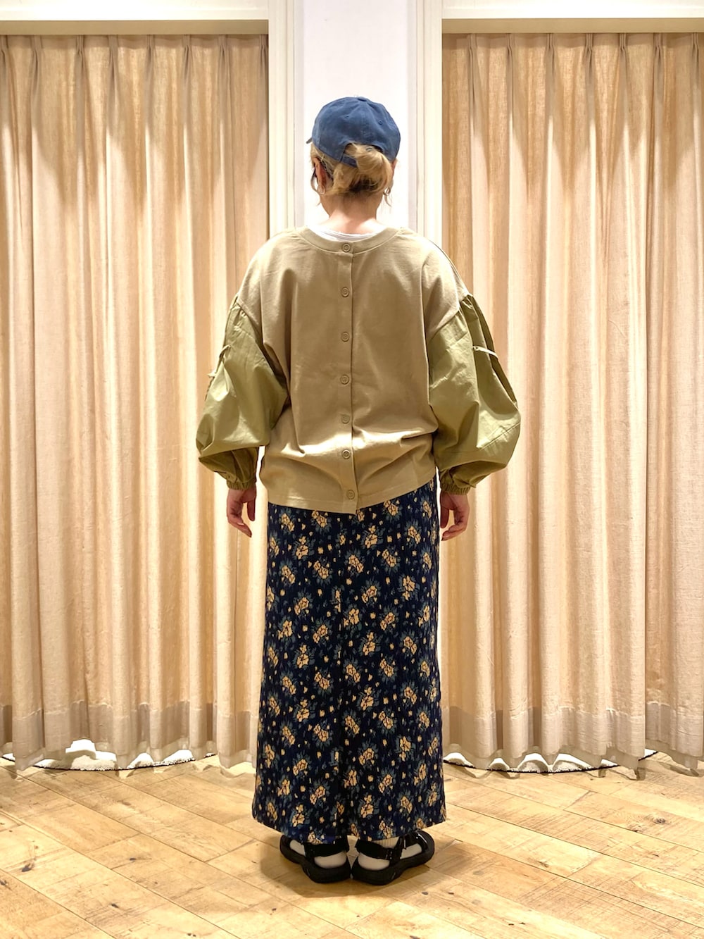 グリーン系のTシャツ/カットソー、ブルー系のスカートを着用したレディースの秋コーディネートの4枚目の写真