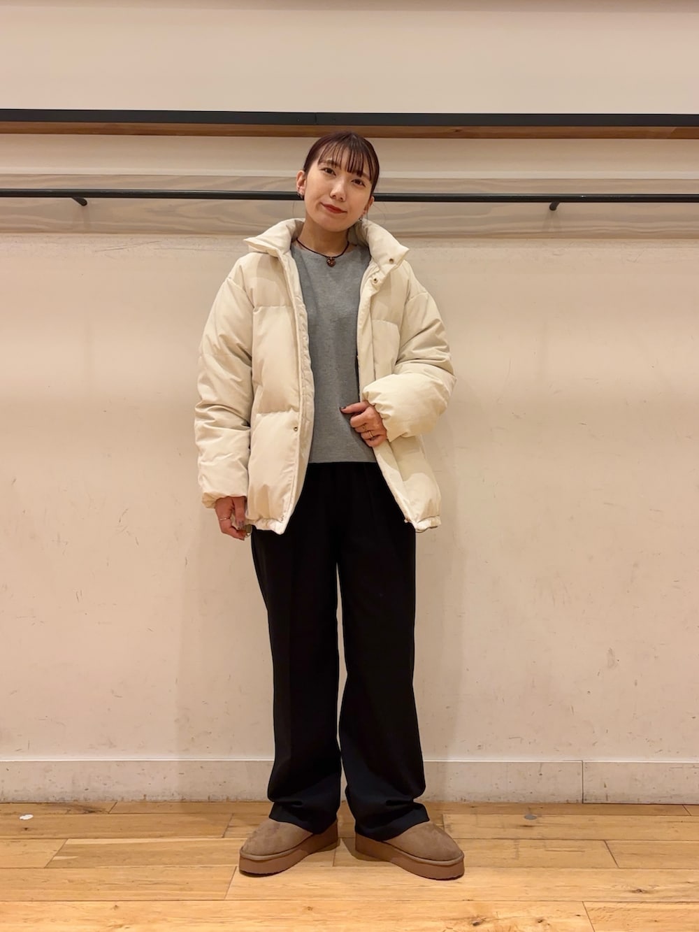 ホワイト系のダウンジャケット/コート、グレー系のニット/セーター、ブラック系のその他パンツを着用したレディースの冬コーディネートの3枚目の写真