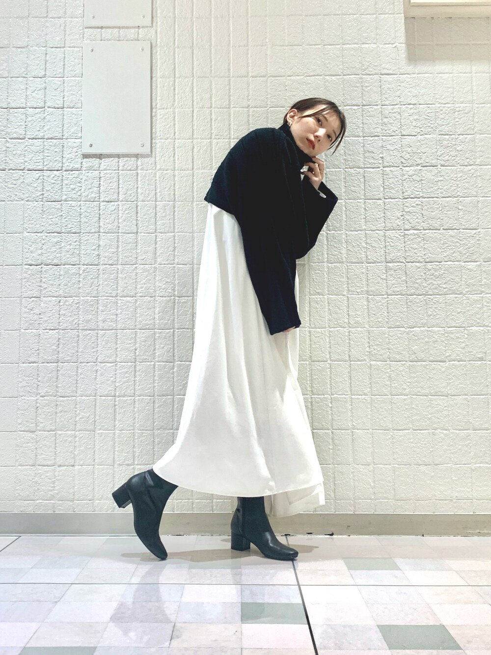 ブラック系のワンピース、ブラック系のブーツを着用したレディースの秋コーディネートの2枚目の写真