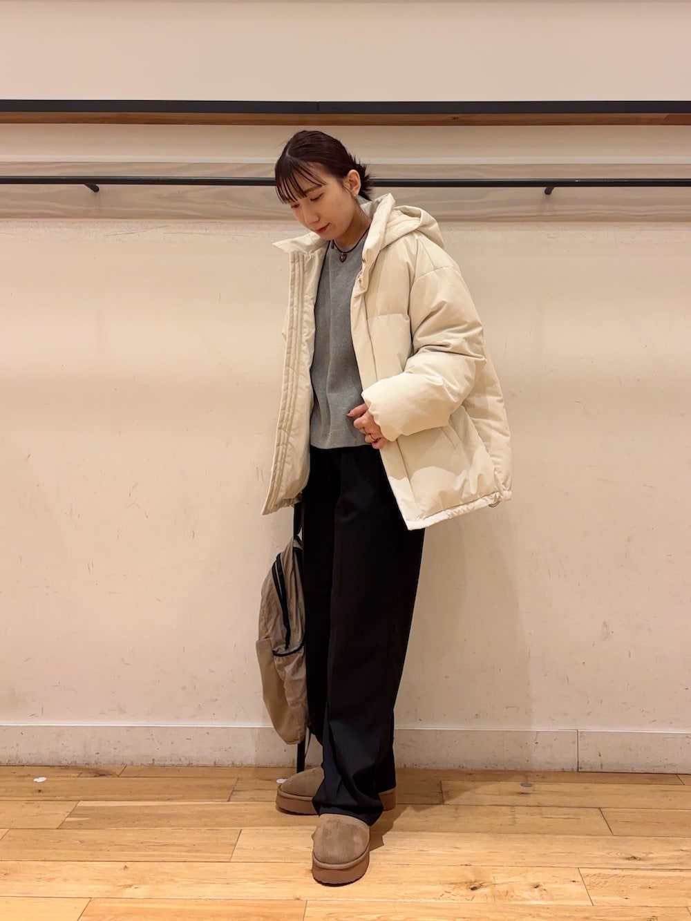 ホワイト系のダウンジャケット/コート、グレー系のニット/セーター、ブラック系のその他パンツを着用したレディースの冬コーディネートの4枚目の写真