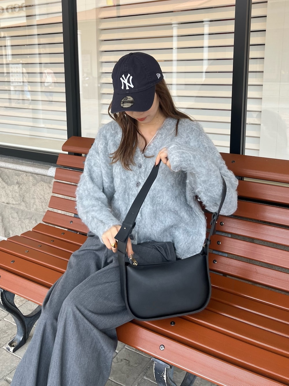 ブラック系のショルダーバッグ、グレー系のカーディガン/ボレロを着用したレディースの秋コーディネートの2枚目の写真