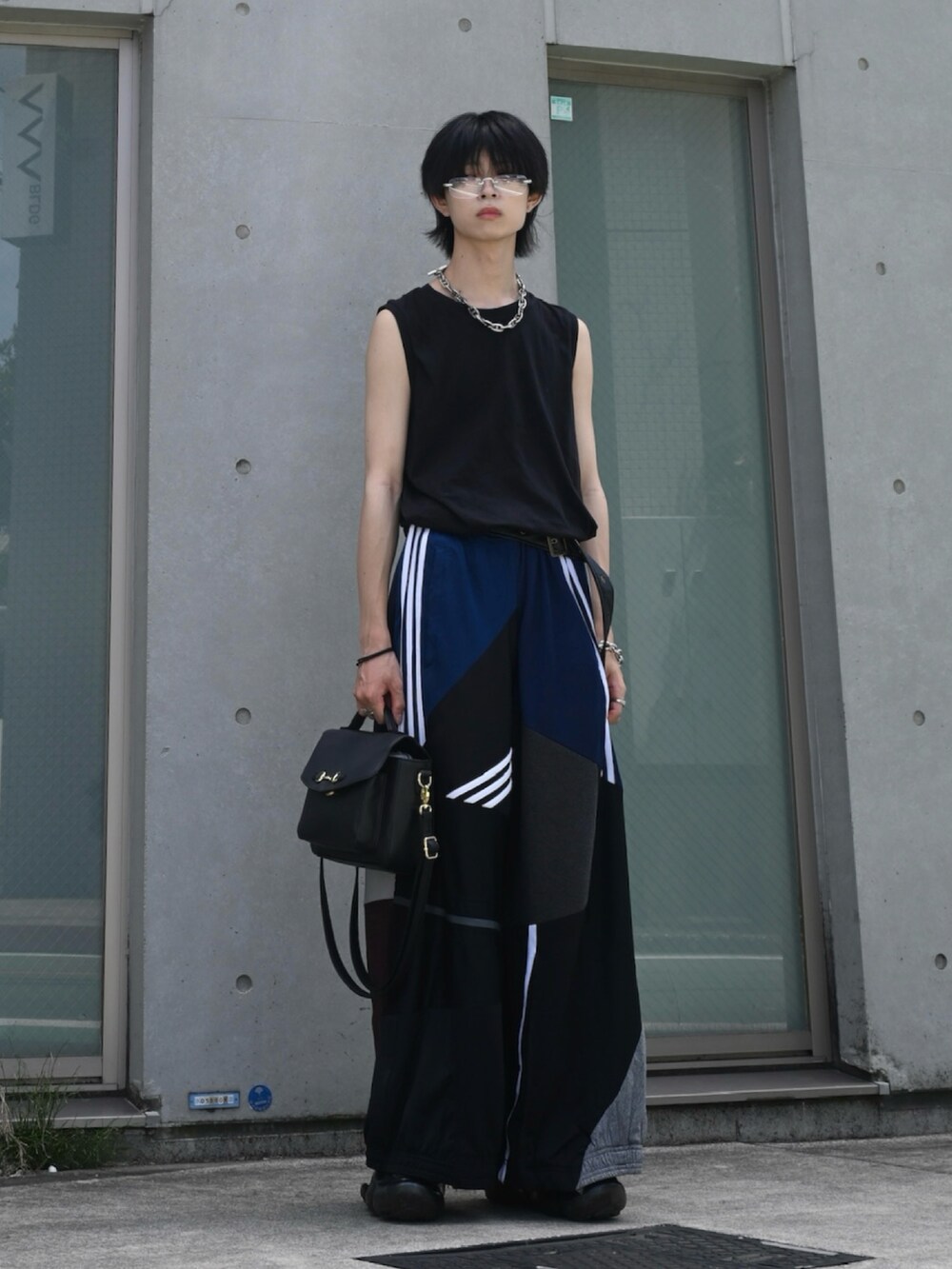 ブラック系のタンクトップ、ブラック系のショルダーバッグ、その他のスウェットパンツを着用したメンズの夏コーディネートの2枚目の写真