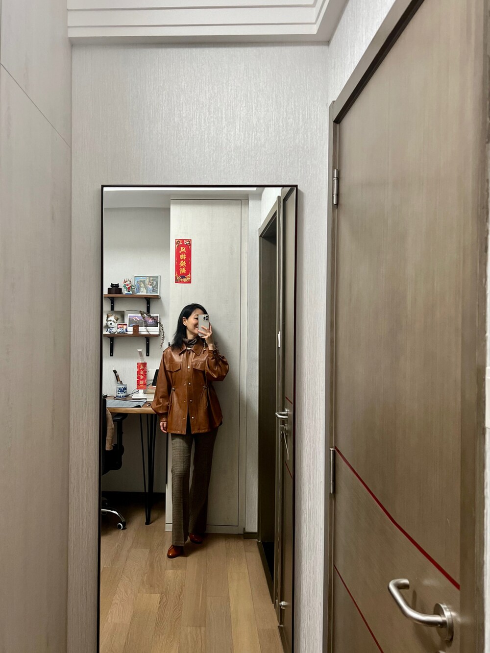 ブラウン系のムートンコートを着用したレディースの秋コーディネートの2枚目の写真