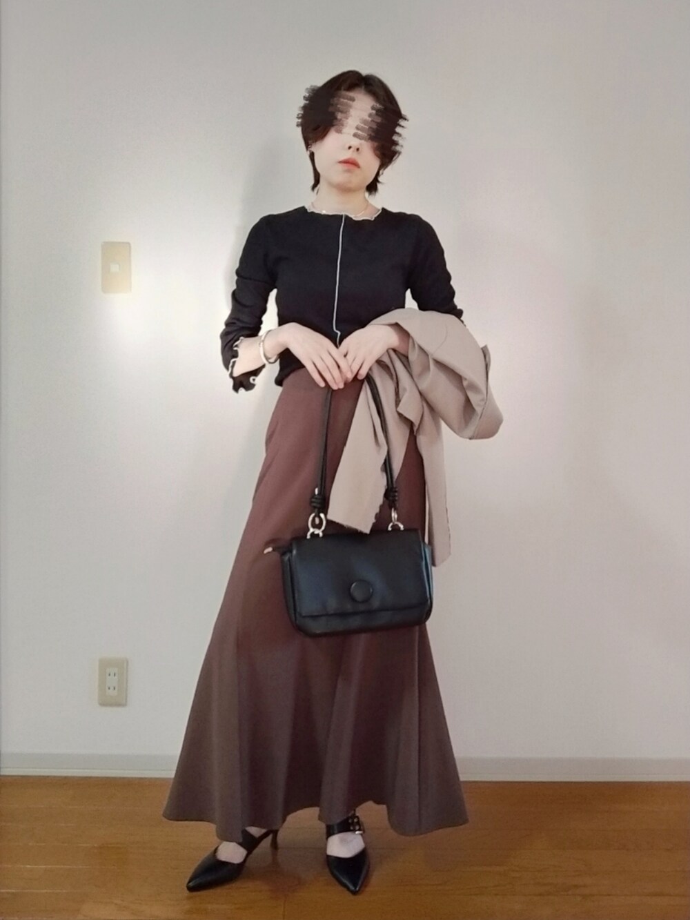 ブラック系のTシャツ/カットソー、ベージュ系のテーラードジャケット、ブラック系のショルダーバッグを着用したレディースの秋コーディネートの4枚目の写真