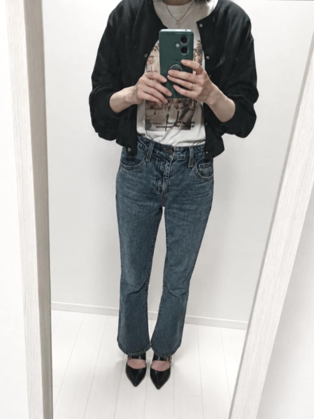ブラック系のカーディガン/ボレロ、ブルー系のデニムパンツ、ブラック系のパンプスを着用したレディースの夏コーディネートの2枚目の写真