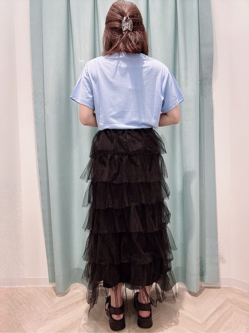 ブルー系のTシャツ/カットソー、ブラック系のスカート、ブラック系のサンダルを着用したレディースの夏コーディネートの3枚目の写真